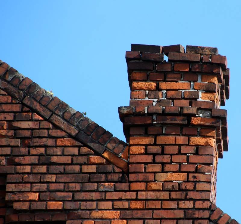 Damaged chimney on an Marblehead home showing cracks and missing mortar